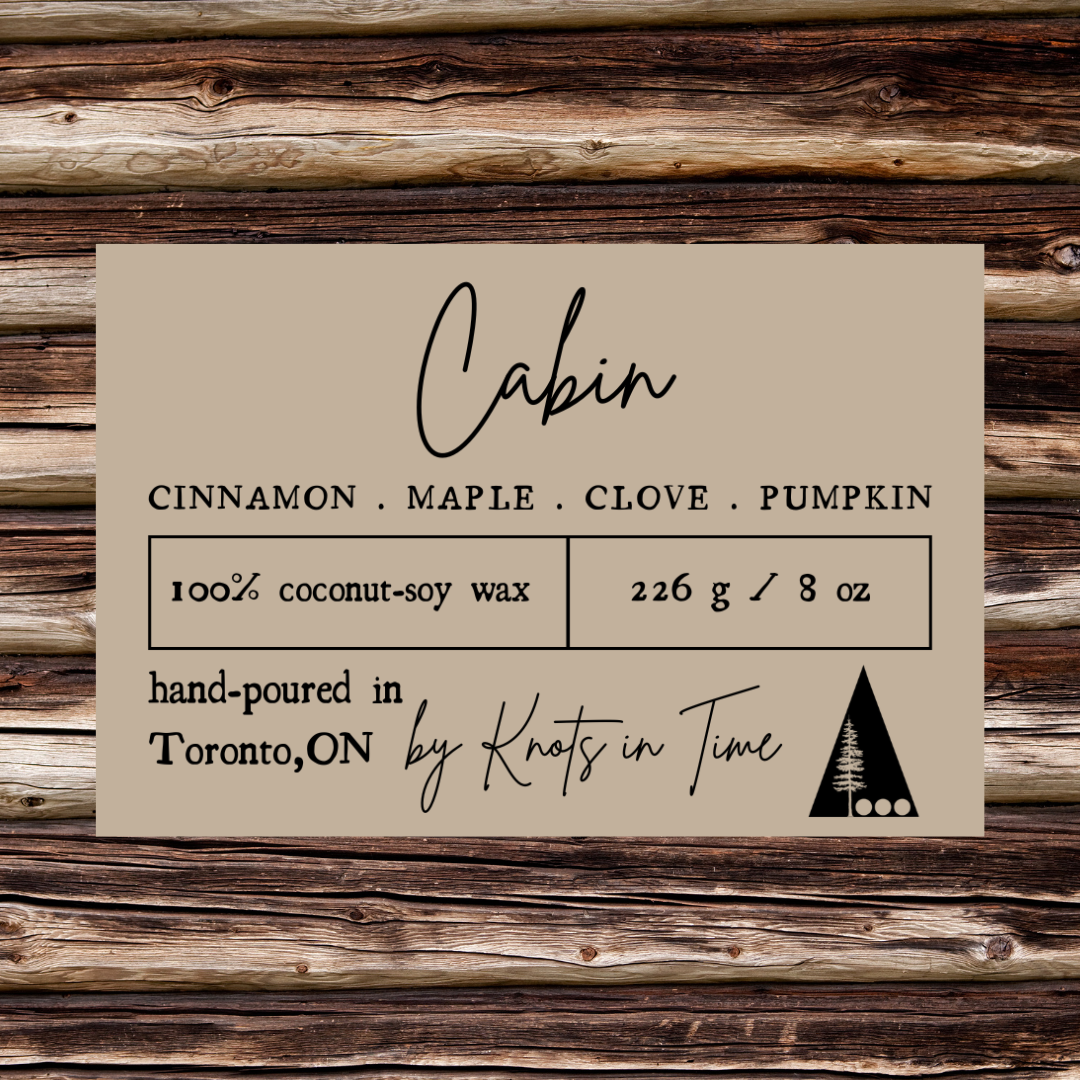 Label for candles with 'Cabin' scent on a wooden background