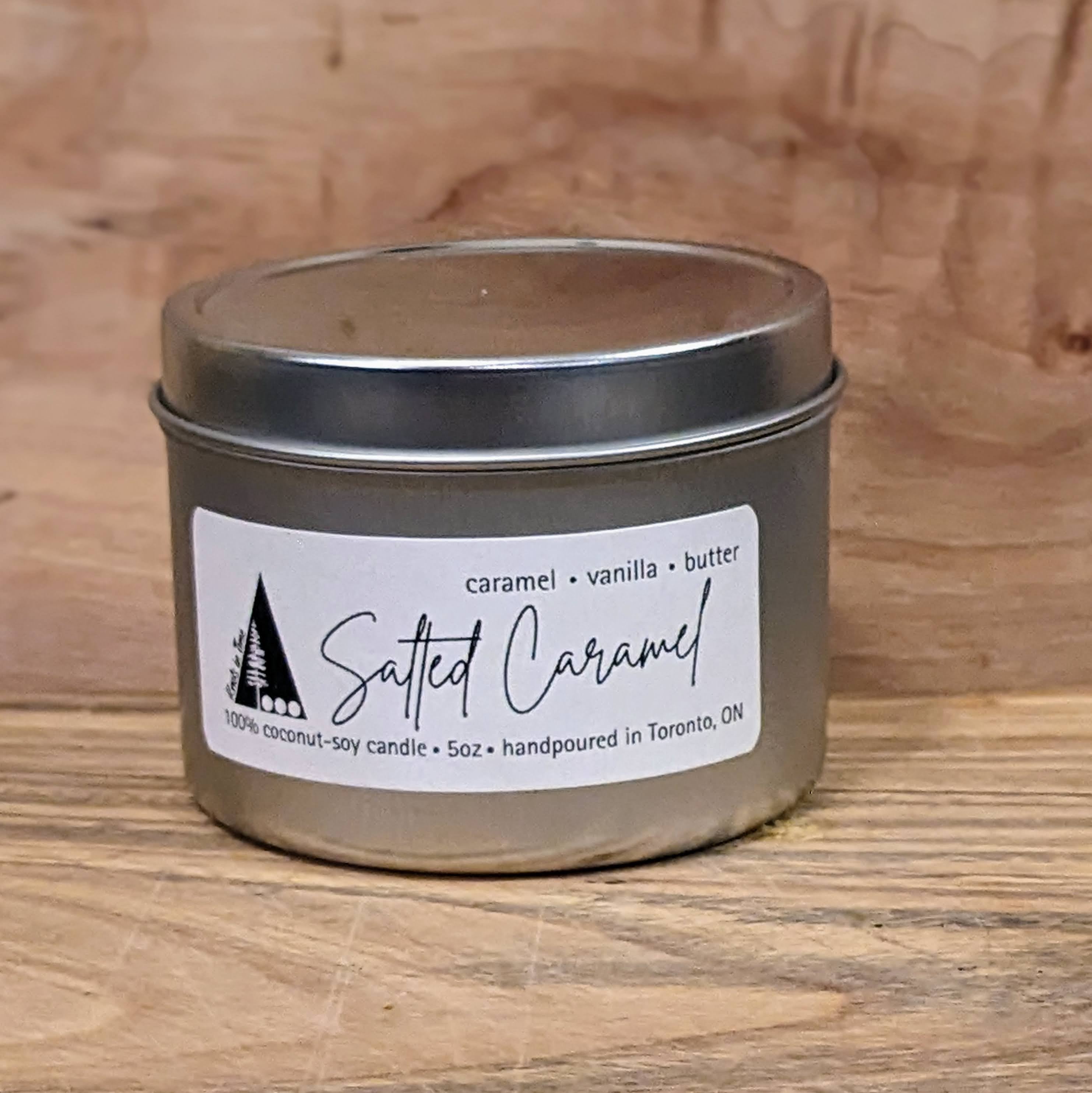 5oz silver metal tin with a lid and white label and black writing.  Name of candle is Salted Caramel