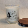 Candle with 'Earth's Essence' label on a textured surface