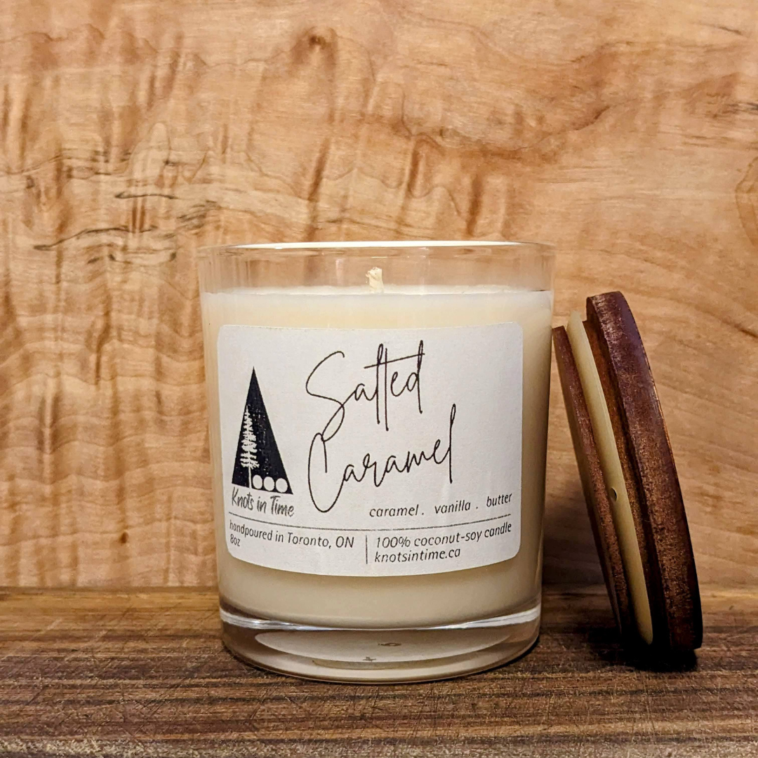 Candle with a label on a wooden surface