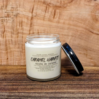 Candle jar labeled 'Caramel Harvest' on a wooden surface